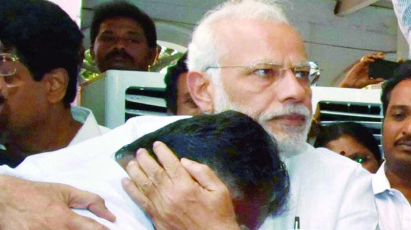 Prime Minister Narendra Modi consoles new Tamil Nadu chief minister O. Panneerselvam in Chennai