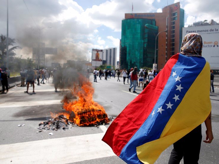 Protesters clash with riot police during a rally to demand a referendum to remove Venezuela's President Nicolas Maduro in Caracas Venezuela