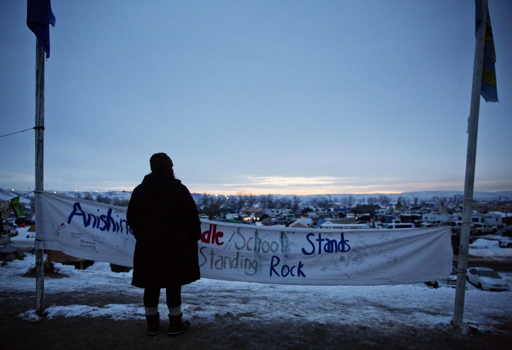 Oil Pipeline A person looks out over the Oceti Sakowin camp where people have gathered to protest the Dakota Access oil pipeline as the sun rises in Cannon Ball N.D. Monday Dec. 5 2016. Protesters who celebrated a major victory in their push to rerout