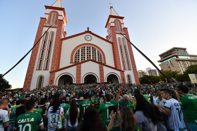 People surround a church during a mass in memoriam of the players of Brazilian team Chapecoense Real killed in a plane crash in the Colombian mountains in Chapeco in the southern Brazilian state of Santa Catarina