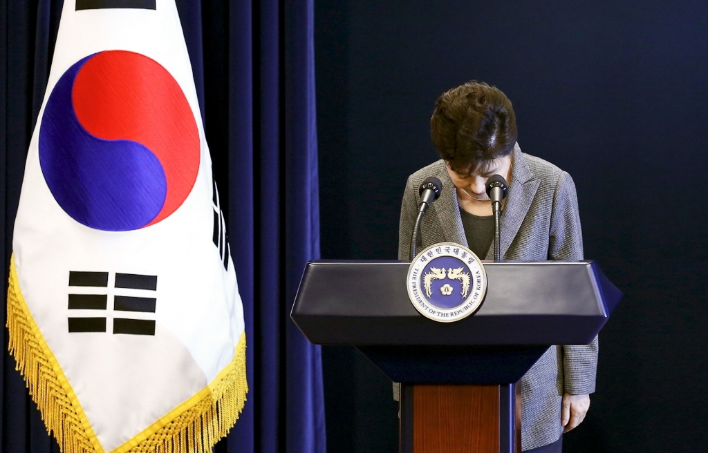 South Korean President Park Geun-hye bows during her address to the nation while saying she'll resign if parliament comes up with a plan for the safe transfer of power at the preside