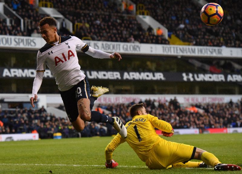 Swansea City's goalkeeper Lukasz Fabianski saves a shot from Tottenham Hotspur's midfielder Dele Alli during the English Premier League football match between Tottenham Hotspur and Swansea City