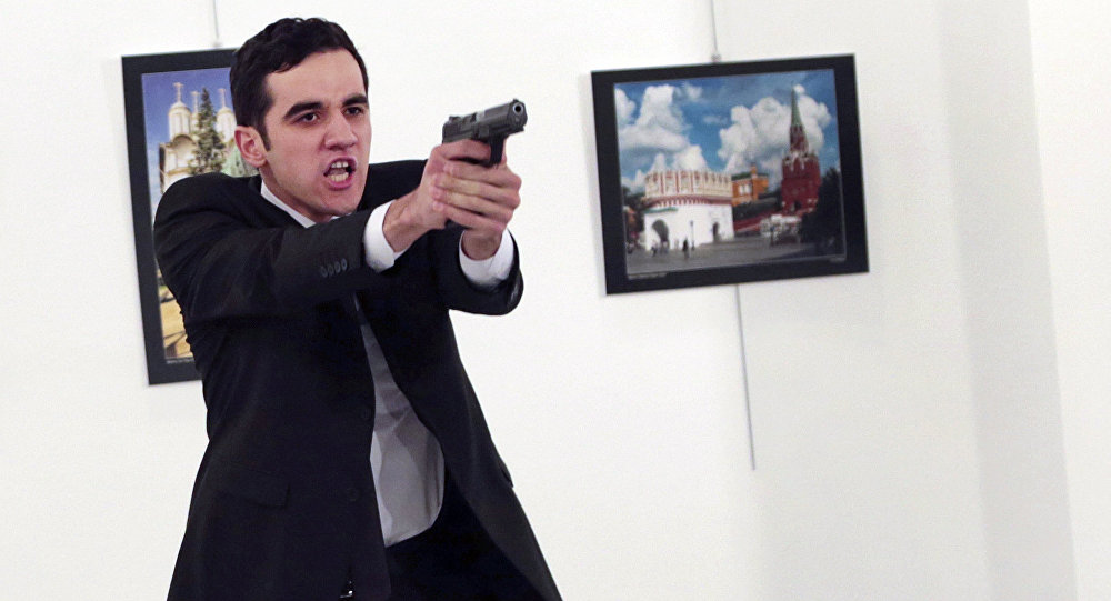 An unnamed gunman gestures after shooting the Russian Ambassador to Turkey Andrei Karlov at