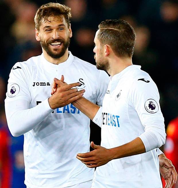 Swansea City's Fernando Llorente celebrates scoring their fifth goal with Gylfi Sigurdsson