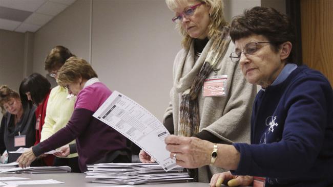 Tabulators look over a ballot during a statewide presidential election recount Thursday