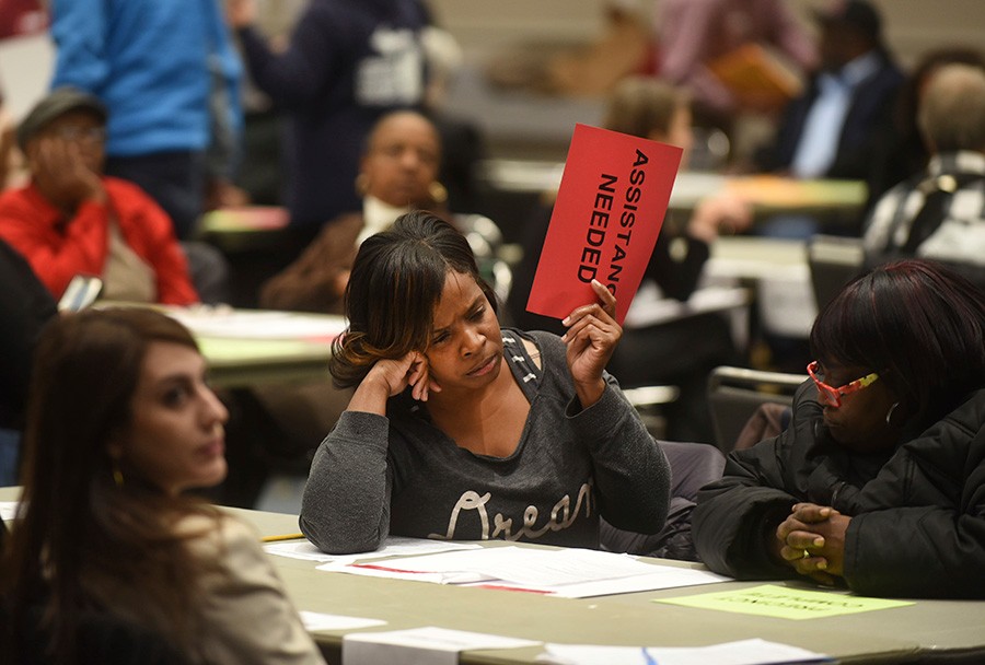 Vonettia Midgett of Detroit awaits assistance as the massive recount begins in Wayne County Michigan Tuesday