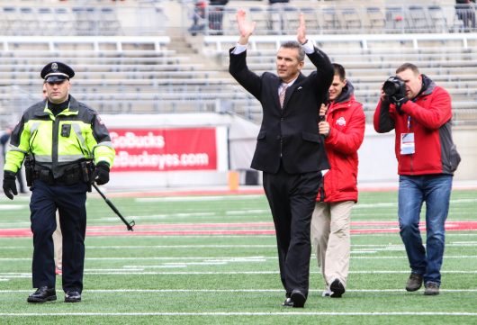 OSU coach Urban Meyer greets fans with an'O-H before the Buckeyes 30-27 double overtime win against Michigan on Nov. 26. Credit Alexa Mavrogianis