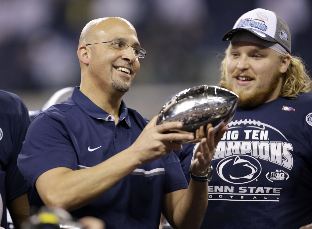 Penn State head coach James Franklin holds the trophy after defeating Wisconsin to with the Big Ten championship NCAA college football game Sunday Dec. 4 2016 in Indianapolis. Penn State won 38-31