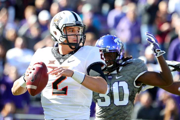 Tom Pennington 
 

  Mason Rudolph of Oklahoma State celebrates with fans after beating TCU on Nov. 19