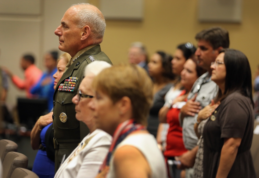 U.S. Marine General John Kelly stands at attention while the National Anthem is played during a ceremony to remember and honor those who have died in service to the nation and the families they have left behind at U.S. Southern Command headquarters on Ma