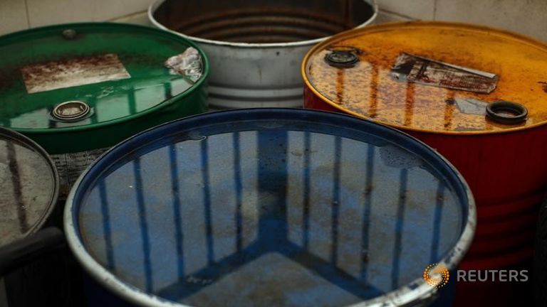 Used oil barrels are seen outside a garage in Cuevas del Becerro near Malaga southern Spain