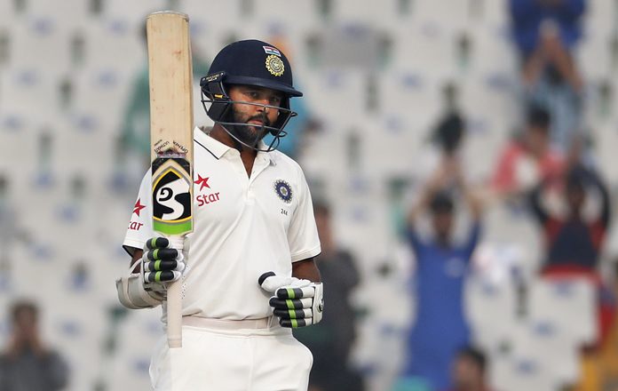 India's Parthiv Patel raises his bat after scoring a half-century on the fourth day of the third test against England in Mohali India Tuesday Nov. 29