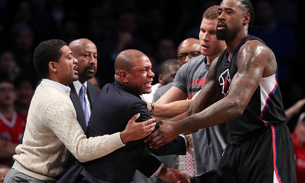 NEW YORK NY- NOVEMBER 29 Head coach Doc Rivers of the Los Angeles Clippers is held back by De Andre Jordan #6 and Blake Griffin #32 after a technical foul call against the Brooklyn Nets in overtime at Barclays Center