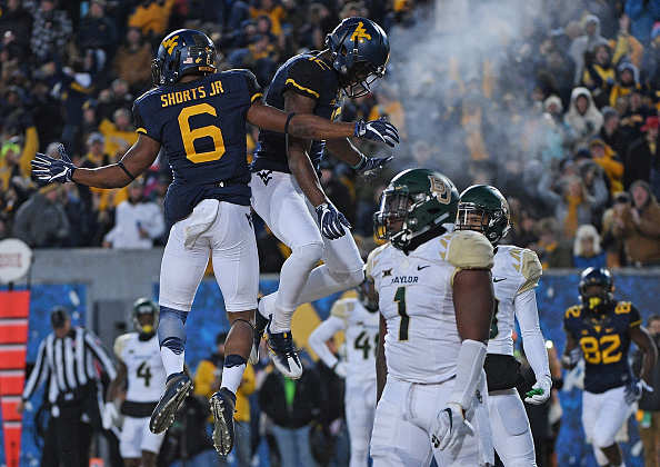 MORGANTOWN WV- DECEMBER 03 Daikiel Shorts #6 of the West Virginia Mountaineers celebrates his 4 yard touchdown reception with Gary Jennings #12 in the second quarter during the game against the Baylor Bears at Mountaineer Field