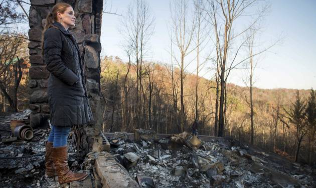 Veronica Carney looks at the skyline from the remains of the home she grew up in Thursday Dec. 1 2016 in Gatlinburg Tenn. Carney flew in from Massachusetts to assist her parents Richard T. Ramsey and Sue Ramsey who safely evacuated as a wildfire app