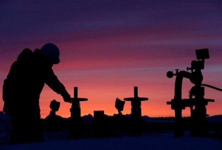 A worker checks the valve of an oil pipe at an oil field owned by Russian state-owned oil producer Bashneft near the village of Nikolo-Berezovka northwest of Ufa Bashkortostan Russia