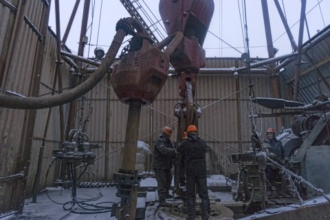 Workers position pipes on a drilling platform in Gnidyntsi Ukraine on Nov. 29