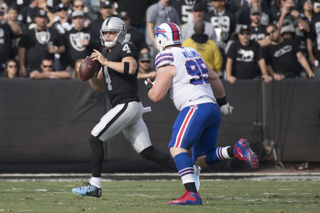 Oakland CA USA Oakland Raiders quarterback Derek Carr passes the football against Buffalo Bills defensive end Kyle Williams during the first quarter at Oakland Coliseum. Mandatory Credit Kyle Terada-USA TODAY Sports