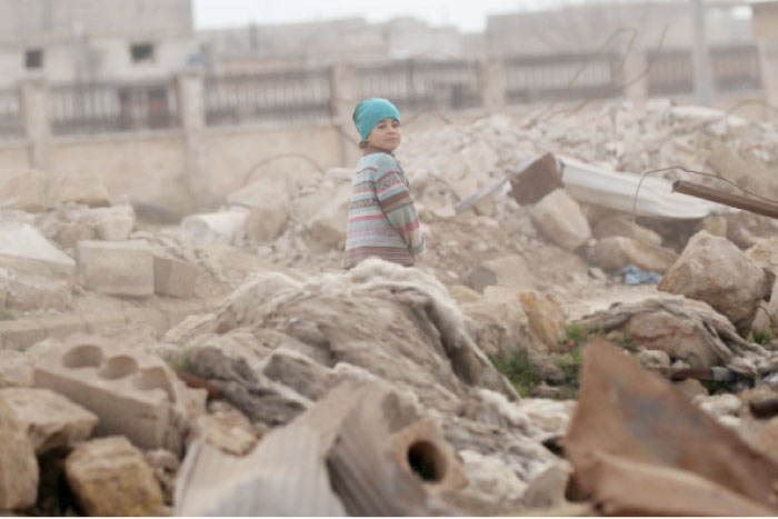 A child walks through rubble of damaged buildings in Al Rai town northern Aleppo countryside. — Reuters