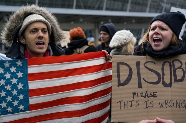 Protesters assemble at John F. Kennedy International Airport in New York Saturday Jan. 28 2017 after two Iraqi refugees were detained while trying to ente