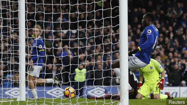 Everton's Tom Davies scores their third goal as Romelu Lukaku looks