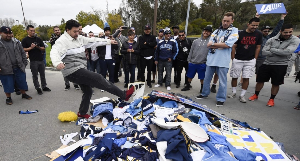 Chris Githens left kicks a pile of Chargers memorabilia in front of San Diego Chargers headquarters after the team announced that it will move to Los Angeles Thursday Jan. 12 2017 in San Diego