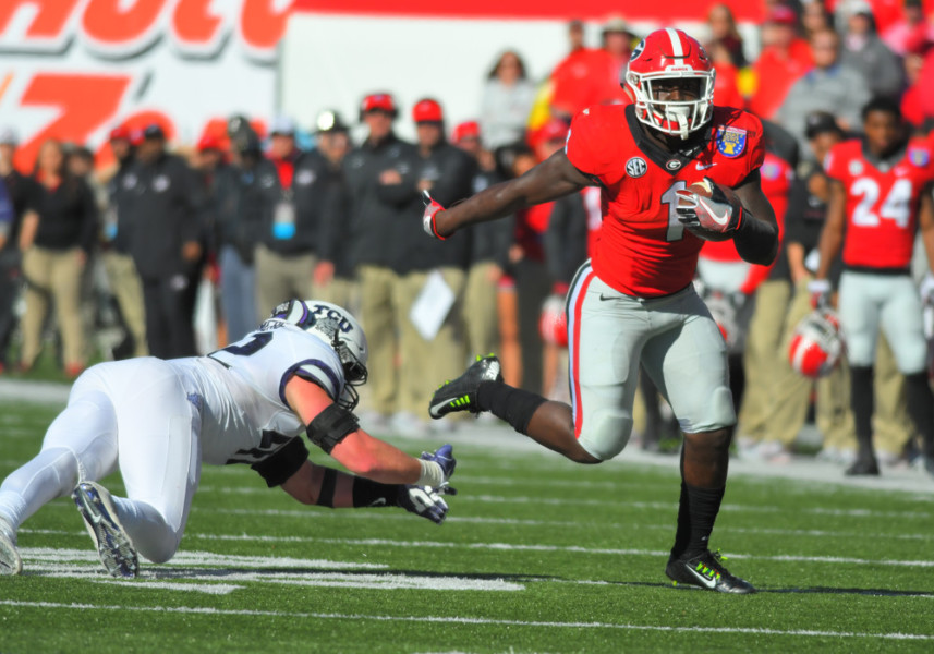 MEMPHIS TN- DECEMBER 30 Sony Michel Georgia Bulldogs running back eludes Ty Summers TCU Horned Frogs linebacker attempt to tackle him during the Auto Zone Liberty Bowl between the Georgia Bulldogs and the TCU Horned Frogs on December 30 2016