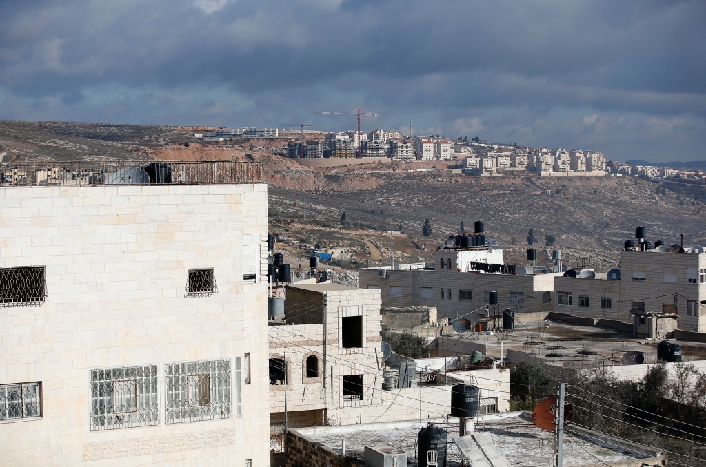 3 2017 shows Israeli construction cranes and excavators at a building site of new housing units in the Jewish settlement of Kochav Ya'akov near the West Bank city of Ramallah, adjacent to Qalandiya refugee camp.  AFP  A