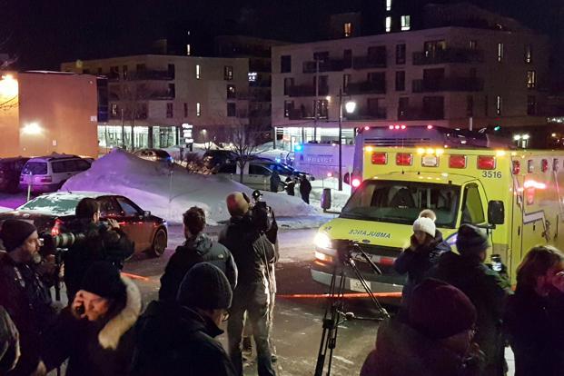 An ambulance is parked at the scene of a fatal shooting at the Quebec Islamic Cultural Centre in Quebec City Canada on Sunday