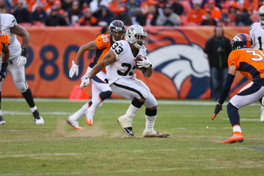DENVER CO- JANUARY 01 Oakland Raiders running back De Andre Washington runs with the ball during a game between the Denver Broncos and the Oakland Raiders