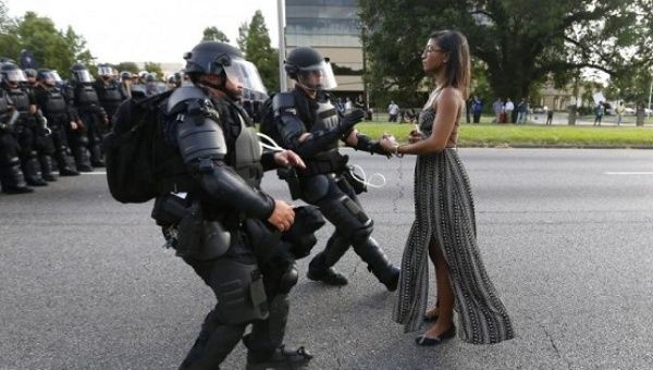 A demonstrator protesting the shooting death of Alton Sterling is detained by police near in Baton Rouge Louisiana