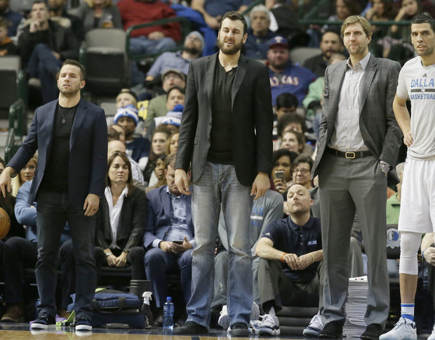 Dallas Mavericks guard J.J. Barea left Dallas Mavericks center Andrew Bogut center and forward Dirk Nowitzki watch from the sidelines during the second half of an NBA basketball game against the Indiana Pacers in Dallas Friday Dec. 9 2016. (AP Phot