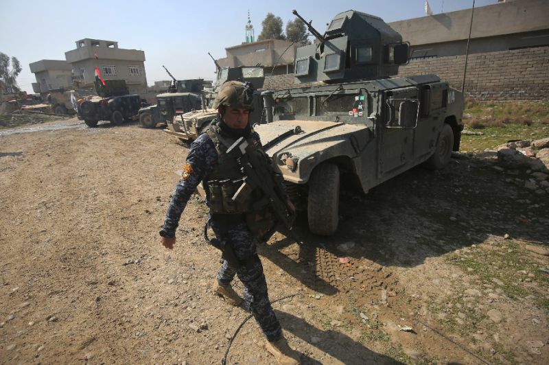 An Iraqi forces member patrols in the Dindan neighbourhood of Mosul