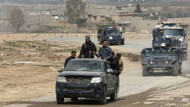 Iraqi forces advance during fighting against Islamic State militants on the western side of Mosul