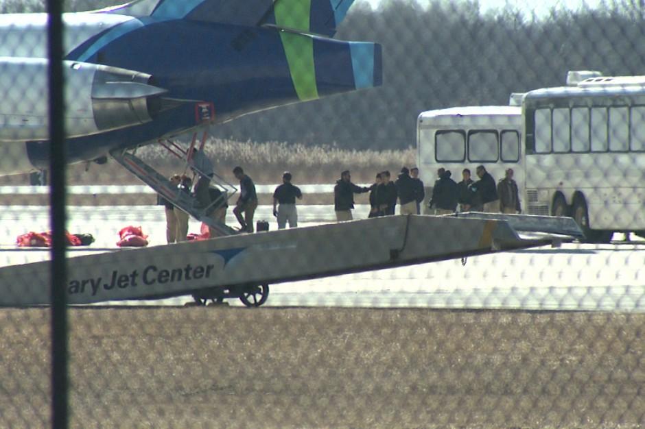 Detainees are searched before boarding a plane for deportation at the Gary  Chicago International Airport