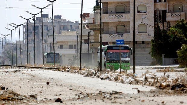 Syrian government buses transport residents from al-Waer the last rebel-held neighbourhood of Homs on Sept. 22 2016