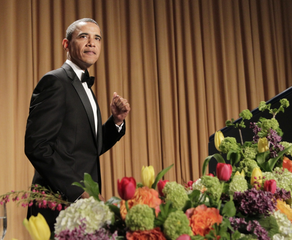 President Barack Obama pumps his fist as he walks to the rostrum during the White House Correspondents Association Dinner in Washington Saturday