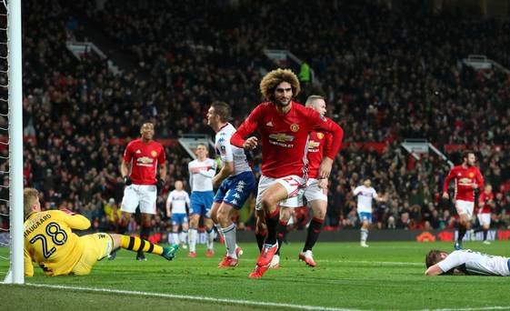 Up and running Marouane Fellaini wheels away after putting United in front at Old
Trafford