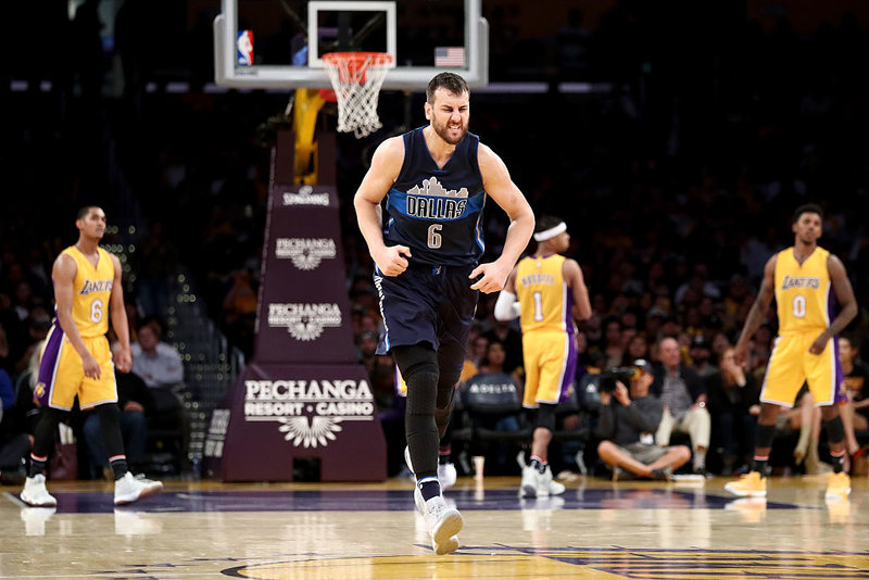 Andrew Bogut #6 of the Dallas Mavericks reacts to scoring during the second half of a game against the Los Angeles Lakers at Staples Center