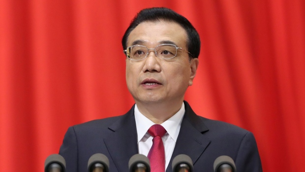 Chinese Premier Li Keqiang delivers a work report during the opening session of the annual National People's Congress at Beijing's Great Hall of the People on Sunday. Li promised more steps to cut surplus steel production that is straining trade