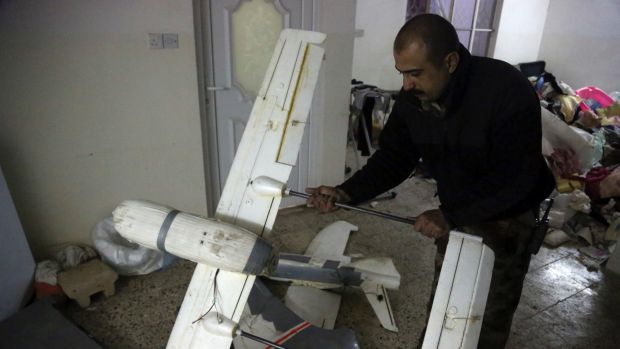 An Iraqi officer inspects drones belonging to Islamic State militants in Mosul