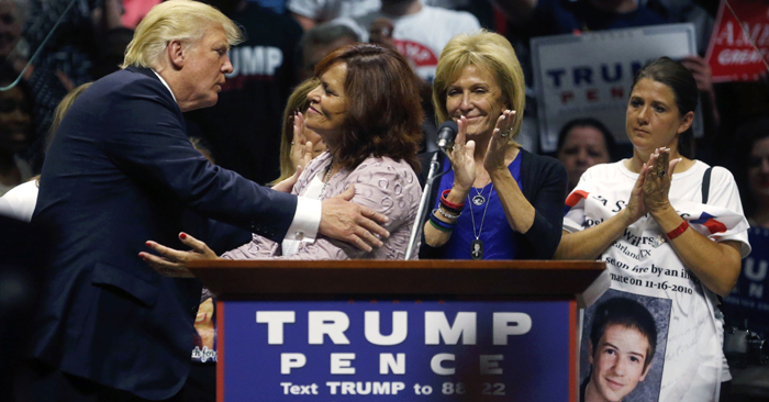 Republican presidential candidate Donald Trump kisses mothers from the Remembrance Project who have lost sons to violence by undocumented immigrants as he speaks at a campaign rally in Austin Texas Tuesday Aug. 23 2016