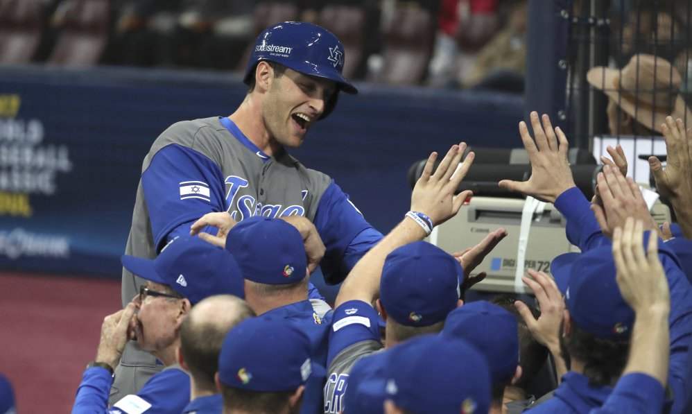 Israel's Nate Freiman celebrates with teammates after scoring on a bases-loaded walk in the second inning of a 2-1 first-round win over South Korea in the World Baseball Classic on Monday at Gocheok Sky Dome in Seoul South Korea