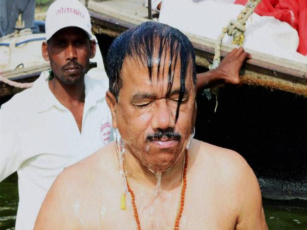 Goa Chief Minister Laxmikant Parsekar takes a dip in the river Ganga at the Sangam in Allahabad in this