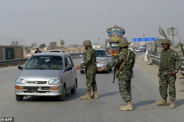 Pakistani paramilitary soldiers stop a vehicle at a security check point in Peshawar