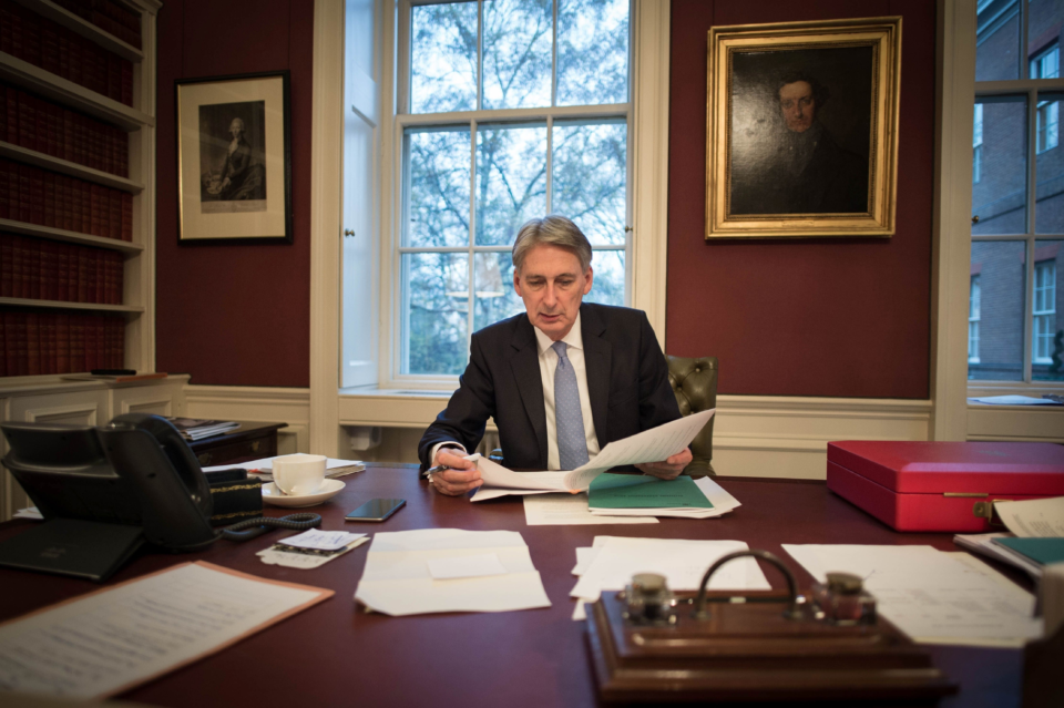 Philip Hammond will use spare cash to build up reserves and reduce debts