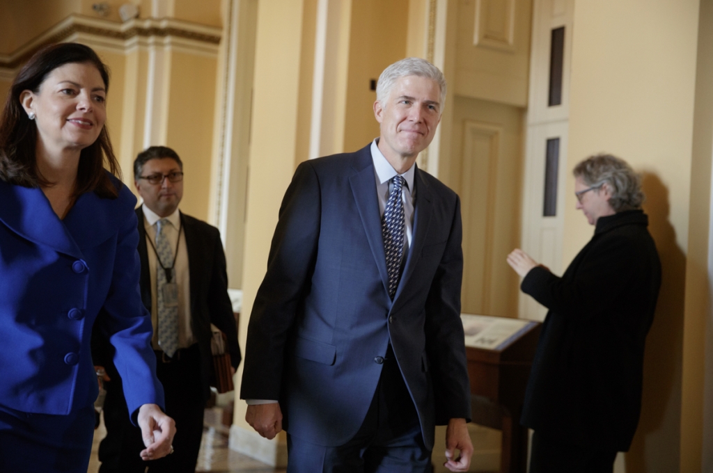 Supreme Court Justice nominee Neil Gorsuch right is escorted by former New Hampshire Sen. Kelly Ayotte on the way to a meeting with Sen. Ted Cruz R-Texas a member of the Senate Judiciary Committee Thursday Feb. 2 2017 on Capitol Hill in Washington