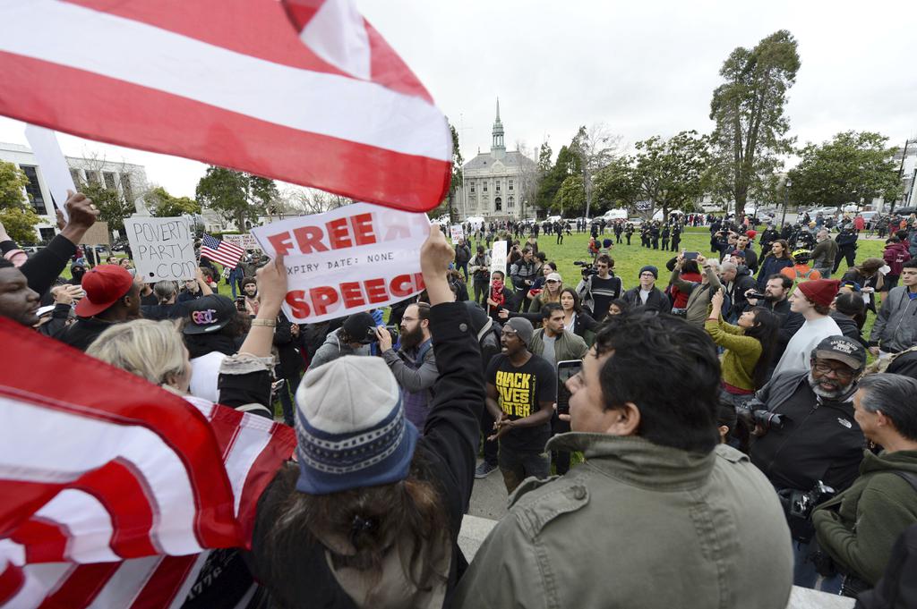 After a short march Trump supporters and anti Trump protesters yell back and forth at a rally for President Donald Trump at Martin Luther King Jr. Civic Center Park in Berkeley Calif. on Saturday