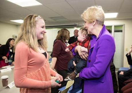 Senator Elizabeth Warren greeted patients Seana Harris and three-month-old Slater Sundquist during her visit to the Manet Community Health Center on Monday in Quincy