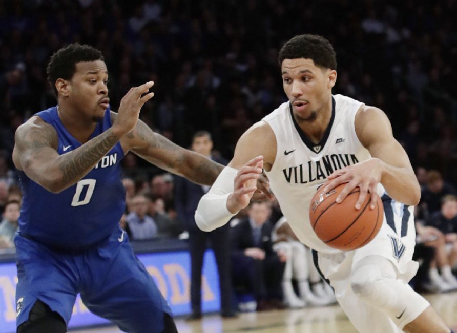 Villanova's Josh Hart right drives past Creighton's Marcus Foster during an NCAA college basketball game in the final of the Big East men's tournament in New York. Villanova the defending tournament champion plays Mount St. Mary's